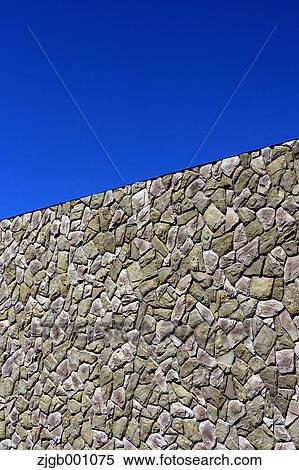 Stock Photography - Stone wall and blue sky. Fotosearch