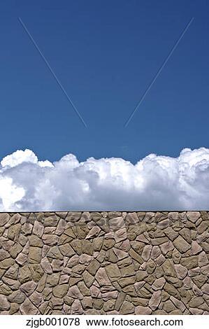 Stone wall and blue sky with clouds View Large Photo Image Stock Photo - Stone wall and blue sky with clouds. Fotosearch