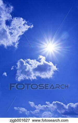 Stock Photo - Sun and sky with clouds. Fotosearch
