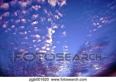 Stock Image - Sunset sky with clouds. Fotosearch