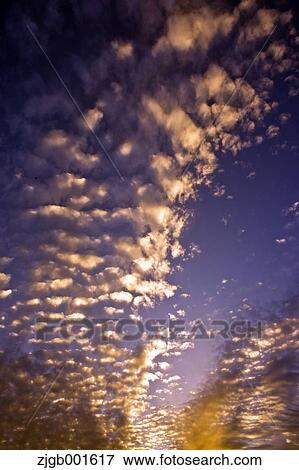 Sunset sky with clouds View Large Photo Image Stock Photo - Sunset sky with clouds. Fotosearch
