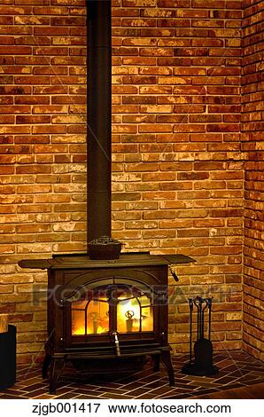 Wood stove and brick wall View Large Photo Image Stock Photo - Wood stove and brick wall. Fotosearch