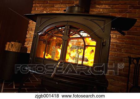 Wood stove and brick wall View Large Photo Image Stock Photo - Wood stove and brick wall. Fotosearch