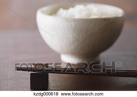 Stock Photo - Chopsticks and rice bowl. Fotosearch