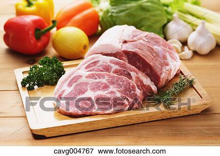Raw pork meat and vegetables View Large Photo Image Stock Photo - Raw pork meat and vegetables. Fotosearch