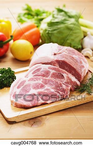 Raw pork meat and vegetables View Large Photo Image Stock Photo - Raw pork meat and vegetables. Fotosearch