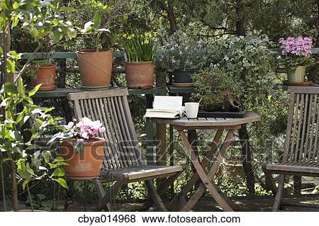 Table and chairs in the garden View Large Photo Image Stock Photo - Table and chairs in the garden. Fotosearch