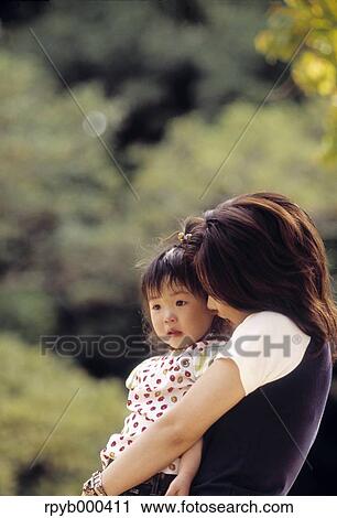 Stock Image - Japanese mother and daughter at the park. Fotosearch