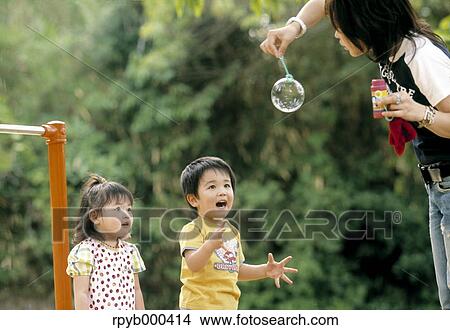 Picture - Japanese mother and kids. Fotosearch