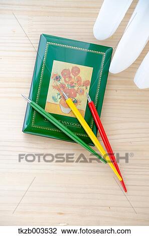 Stock Image - Pencils and book by the window. Fotosearch