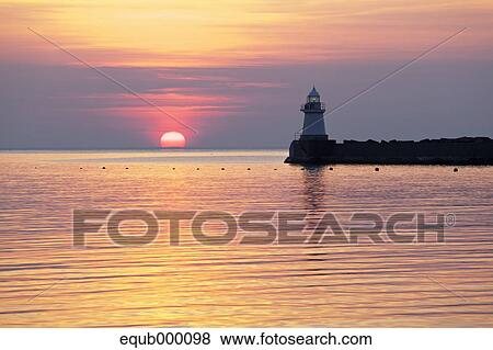 Stock Photo - Sea and lighthouse at sunset, Hokkaido. Fotosearch
