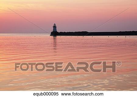 Stock Photography - Sea and lighthouse at sunset, Hokkaido. Fotosearch