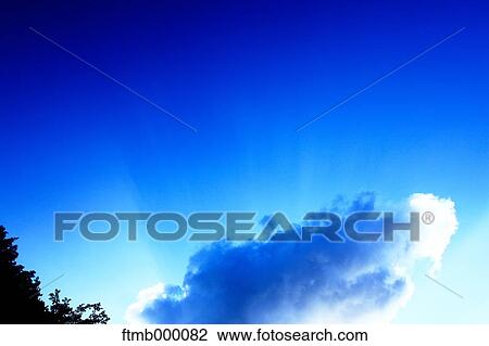 Stock Image - Shaft of light and clouds. Fotosearch