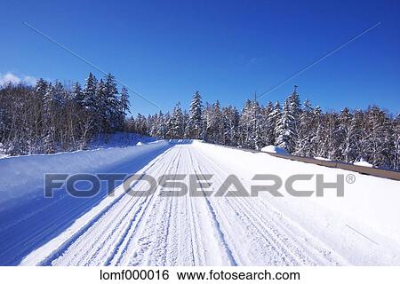 Stock Photograph - Snow covered road, Hokkaido. Fotosearch