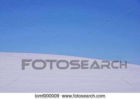 Stock Photo - Snow field and blue sky. Fotosearch
