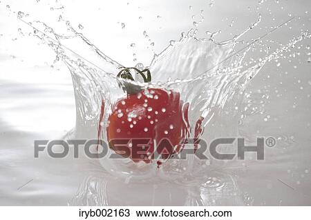Stock Image - Water and tomato. Fotosearch