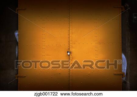 Stock Image - Yellow iron door. Fotosearch