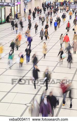 Stock Image - Crowd of pedestrians walking. Fotosearch