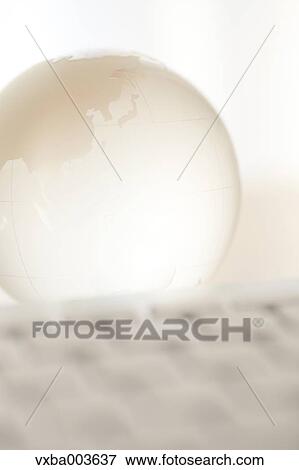 Glass globe and computer View Large Photo Image Stock Photo - Glass globe and computer. Fotosearch