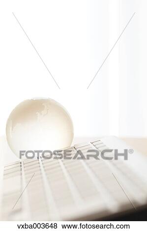 Glass globe and computer View Large Photo Image Stock Photo - Glass globe and computer. Fotosearch