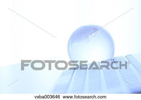 Stock Photograph - Glass globe and computer. Fotosearch