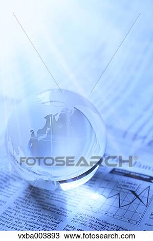 Stock Image - Glass globe and newspaper. Fotosearch