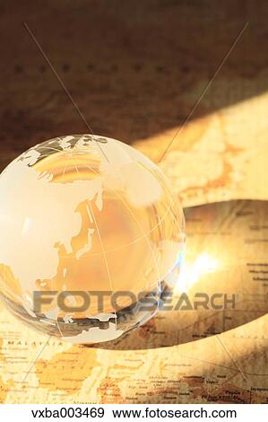 Stock Photo - Glass globe on map. Fotosearch