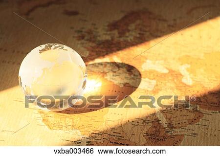 Stock Photograph - Glass globe on map. Fotosearch