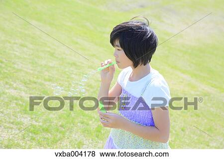 Japanese girl playing in nature View Large Photo Image Stock Photo - Japanese girl playing in nature. Fotosearch