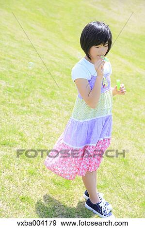 Japanese girl playing in nature View Large Photo Image Stock Photo - Japanese girl playing in nature. Fotosearch