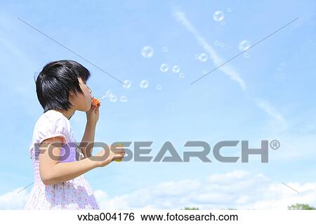 Stock Photograph - Japanese girl playing in nature. Fotosearch