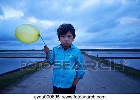 Japanese kid with balloon in the countryside View Large Photo Image Stock Photography - Japanese kid with balloon in the countryside. Fotosearch