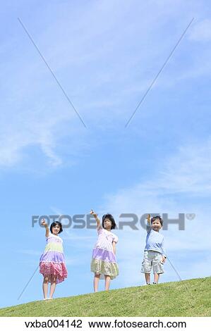 Stock Image - Japanese kids on a hill. Fotosearch