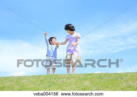 Stock Photograph - Japanese kids on a hill. Fotosearch