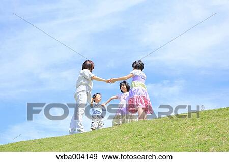 Japanese mum and kids on a hill View Large Photo Image Stock Photo - Japanese mum and kids on a hill. Fotosearch