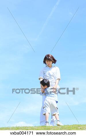 Japanese mum and son on a hill View Large Photo Image Stock Image - Japanese mum and son on a hill. Fotosearch