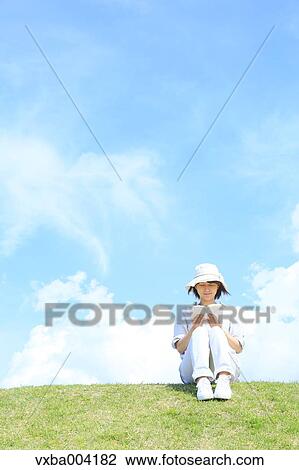 Stock Image - Japanese woman on a hill. Fotosearch