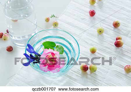 Stock Photo - Rose and fruits in water glasses. Fotosearch