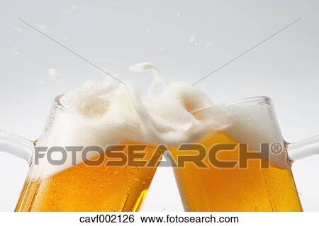 Toasting with beer mugs View Large Photo Image Stock Photograph - Toasting with beer mugs. Fotosearch
