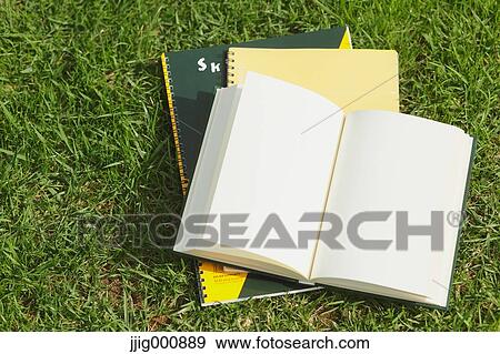 Stock Photo - Book and notebooks on grass. Fotosearch