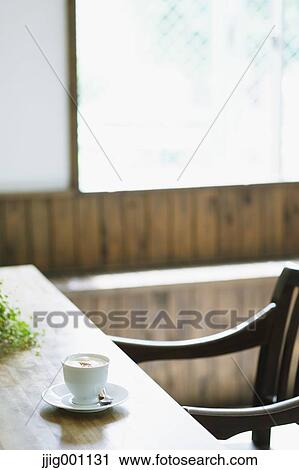 Cappuccino on wooden table in a cafe View Large Photo Image Stock Image - Cappuccino on wooden table in a cafe. Fotosearch