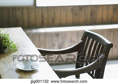 Stock Image - Cappuccino on wooden table in a cafe. Fotosearch