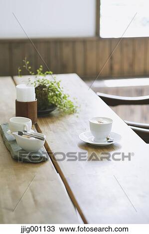 Cappuccino on wooden table in a cafe View Large Photo Image Stock Image - Cappuccino on wooden table in a cafe. Fotosearch