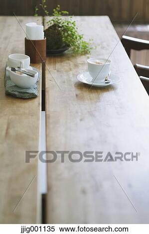 Cappuccino on wooden table in a cafe View Large Photo Image Stock Photography - Cappuccino on wooden table in a cafe. Fotosearch
