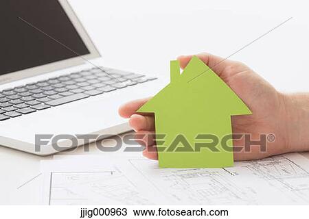 Stock Image - Close up of male hand working in the office. Fotosearch