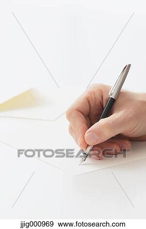 Stock Photo - Close up of male hand writing on paper. Fotosearch