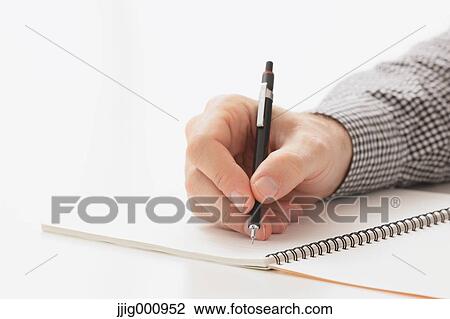 Close up of male hand writing on notebook View Large Photo Image Stock Image - Close up of male hand writing on notebook. Fotosearch