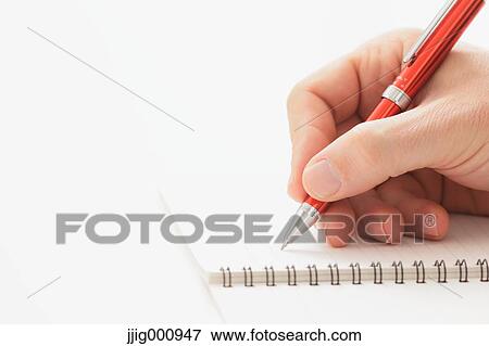 Close up of male hand writing on notebook View Large Photo Image Stock Photo - Close up of male hand writing on notebook. Fotosearch