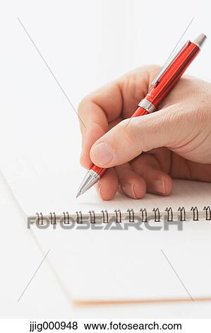 Close up of male hand writing on notebook View Large Photo Image Stock Photo - Close up of male hand writing on notebook. Fotosearch