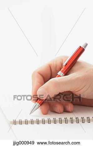 Close up of male hand writing on notebook View Large Photo Image Stock Photo - Close up of male hand writing on notebook. Fotosearch